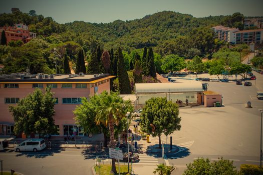 Spain, Catalonia, Tossa de Mar, 20-06-2013, landscape with the bus station and the memorial cemetery of the town, instagram styleeditorial use only