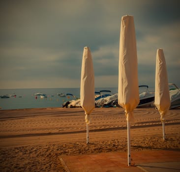 beach, folded umbrellas, early morning, instagram image style