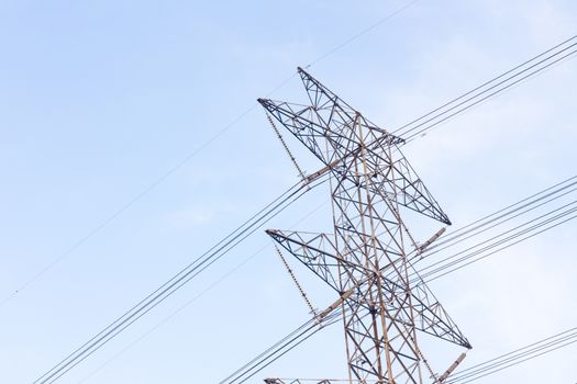high voltage poles in blue sky with cloud