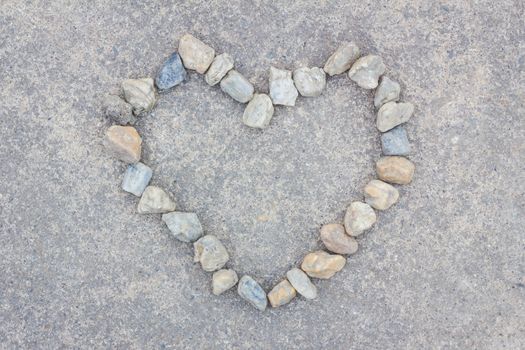 Heart made of stones on concrete background