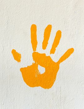 Orange handprint painted on a wall
