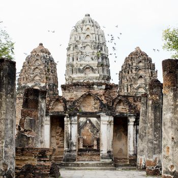 Buddha Statue in Wat Mahathat Temple in Sukhothai Historical park at sunrise, Thailand