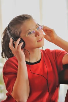  Closeup portrait of beautiful girl with headphones in ears