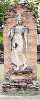 Buddha Statue in Wat Mahathat Temple in Sukhothai Historical park at sunrise, Thailand