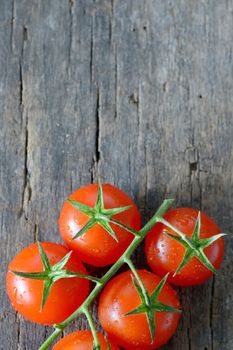 fresh, ripe cherry tomatoes on wood