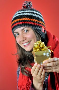 winter girl with gift on red background