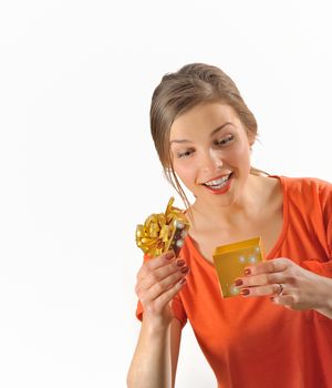 Surprised girl opening the gift box on white background