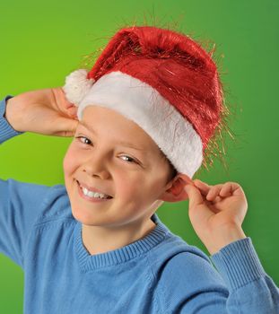 boy with Santa Claus Hat on green background, shoot in studio