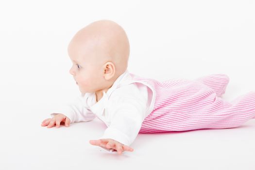 actively crawling wearing a romper baby. studio photo