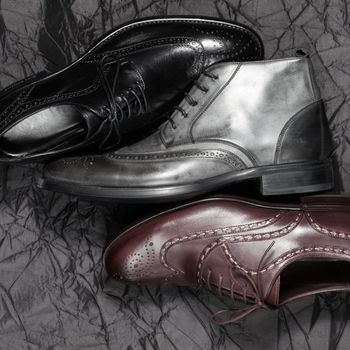 Set of trendy man footwear on a black background
