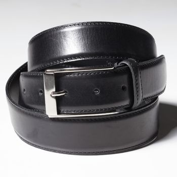 Black belt with a simple buckle on a white background close-up