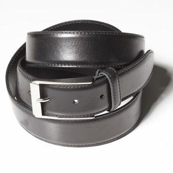 Black belt with a simple buckle on a white background close-up