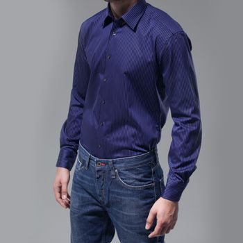Man with blue shirt over dark background