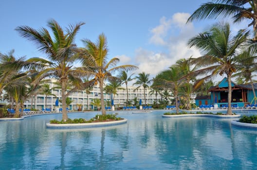 large caribbean swimmming pool with hotel in background
