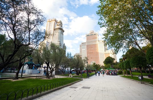 Madrid, Spain - May 6, 2012: Spain Square with monument to Cervantes, Torre de Madrid and Edificio Espana in Madrid on a sunny spring day, Spain