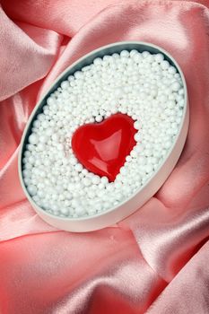 heart shape in polystyrene balls over silk