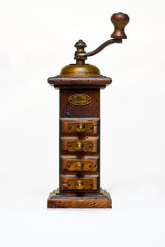 Old wooden pepper mill on white
