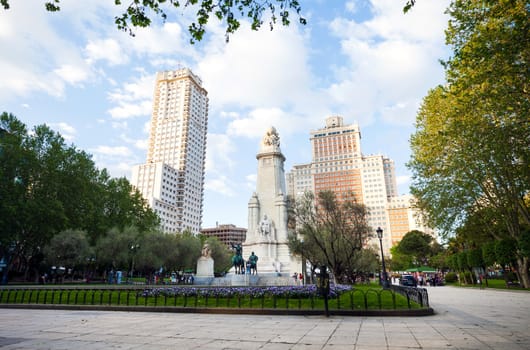 Madrid, Spain - May 6, 2012: Spain Square with monument to Cervantes, Torre de Madrid and Edificio Espana in Madrid on a sunny spring day, Spain