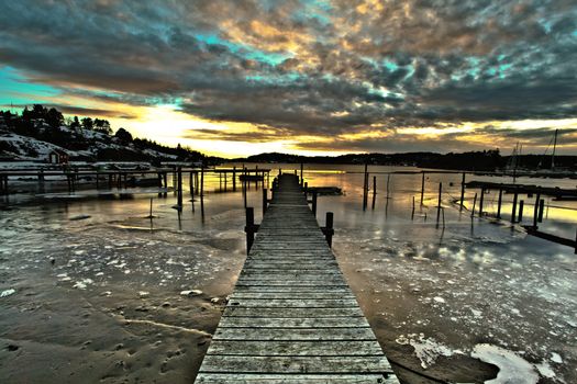 Pier in Fredrikstsd in Norway on the background of the sunset