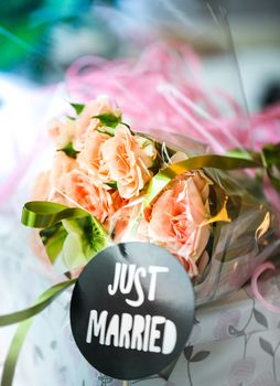 Just married bouquet on blurred colored background