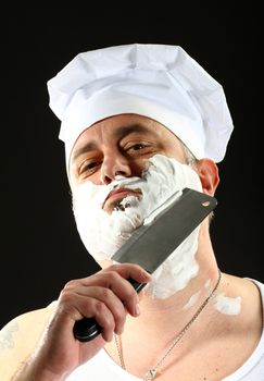 chef shaves with chopper over black