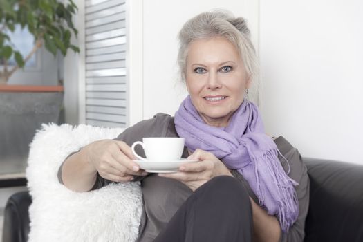 An image of a best age woman with a cup of coffee
