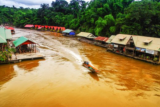 A long-tailed boat running in Kwai-Noi river of Kanchanaburi province, Thailand.