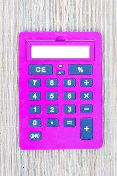 pink calculator on traditional mat with white space on the screen