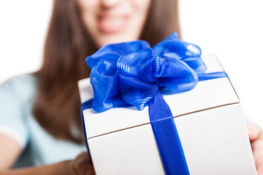Smiling woman hand holding blue ribbon wrapped holiday surprise gift or present box package