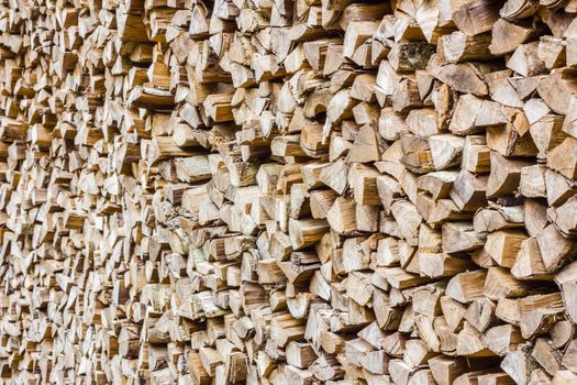 A stack of birch firewood - a natural horizontal background, perspective