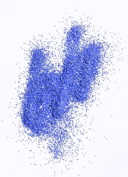 Blue glitter on light background - macro photo