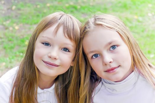 Photo of two cute girls with long hairs