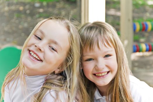 Photo of two smiling girls in summer