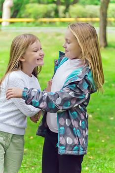 Photo of two playing girls in summer