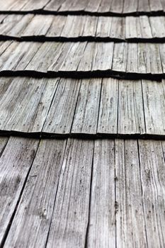 Old wooden shingle roof. Wooden surface texture.