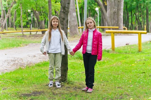 Photo of two playing girls in summer