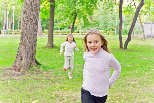 Photo of two running girls in summer