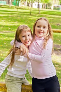 Photo of two playing girls in summer