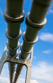 Elevated section of the pipelines with the concrete support against the sky