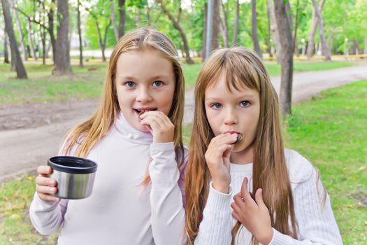 Photo of cute two eating blond girls