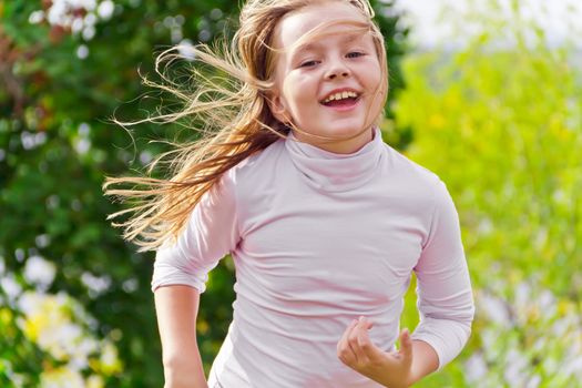 Photo of cute running girl in summer