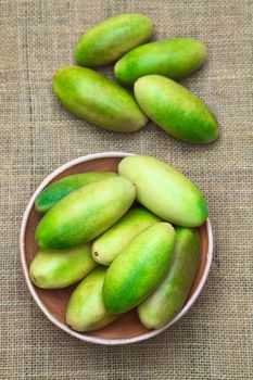 Latin American fruit called banana passionfruit (lat. Passiflora tripartita) (in Spanish mostly tumbo, curuba, taxo) which is used to prepare juice (Selective Focus, Focus on the upper fruits in the bowl)