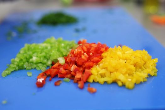 Green red and yellow pepper cubic cutted