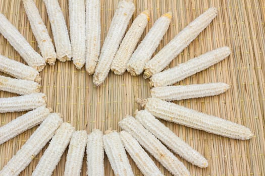 heart shape made of corn cobs on thai traditional mat, love concept