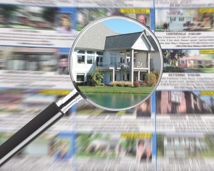 Magnifying glass over real estate section in newspaper