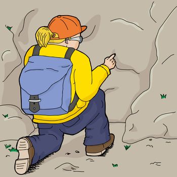 Hiker in yellow kneeling and pointing at rock
