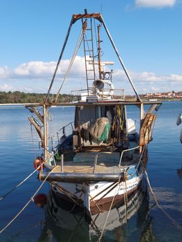 old fishing boat anchored in port   