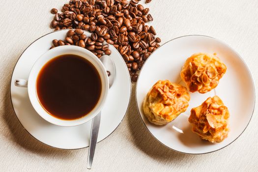 Scone bread and a cup of coffee on white plate