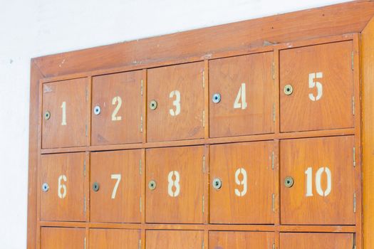 Rows of retro wooden post office boxes.