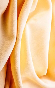 background of bright yellow silk with waves
